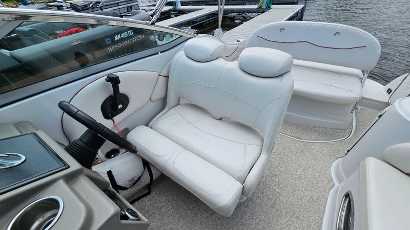Slide: The Image of 2010 Crownline 260 CR boat interior with white leather seats and steering wheel. - 9