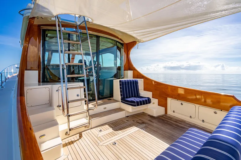 Slide: The Image of 2007 Hinckley Talaria 55 FB yacht deck with striped seating and ocean view. - 10