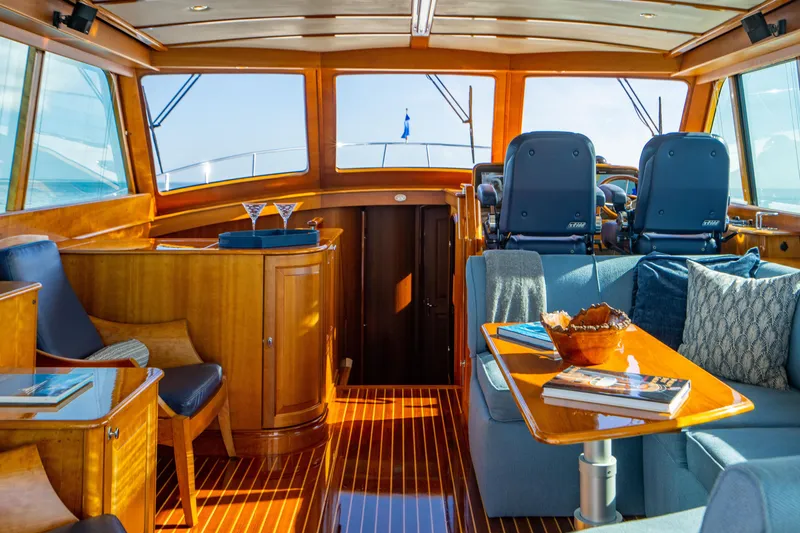 Slide: The Image of Luxurious 2007 Hinckley Talaria 55 FB yacht interior with elegant wood finish and plush seating. - 15