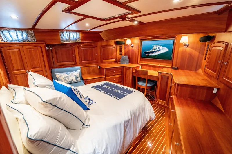 Slide: The Image of Luxurious 2007 Hinckley Talaria 55 FB yacht cabin with elegant wood interior and cozy bedding. - 24