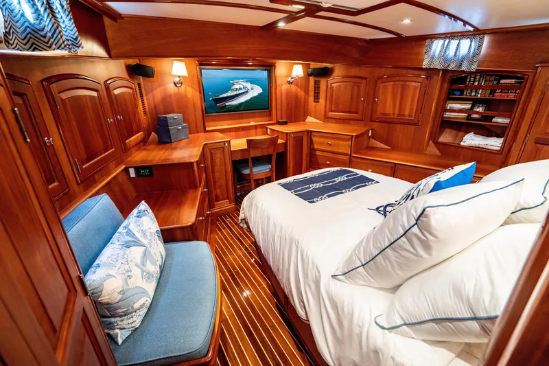 Slide: The Image of Luxurious 2007 Hinckley Talaria 55 FB yacht cabin with elegant wood interior and cozy bedding. - 25
