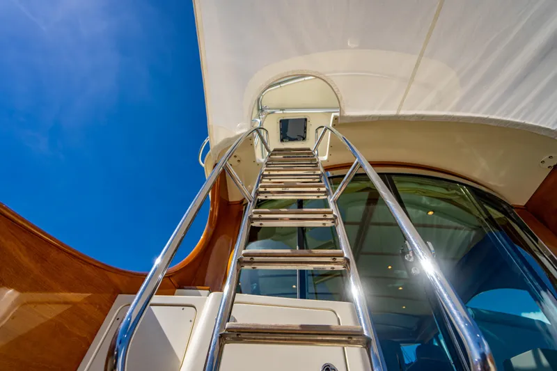 Slide: The Image of Stainless steel ladder on 2007 Hinckley Talaria 55 FB yacht under clear blue sky. - 31