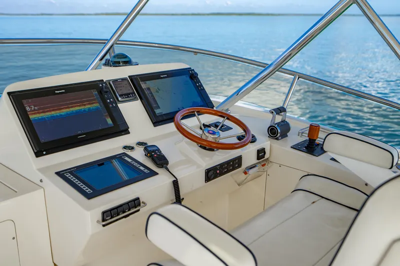 Slide: The Image of Helm of 2007 Hinckley Talaria 55 FB yacht with navigation screens and steering wheel. - 34