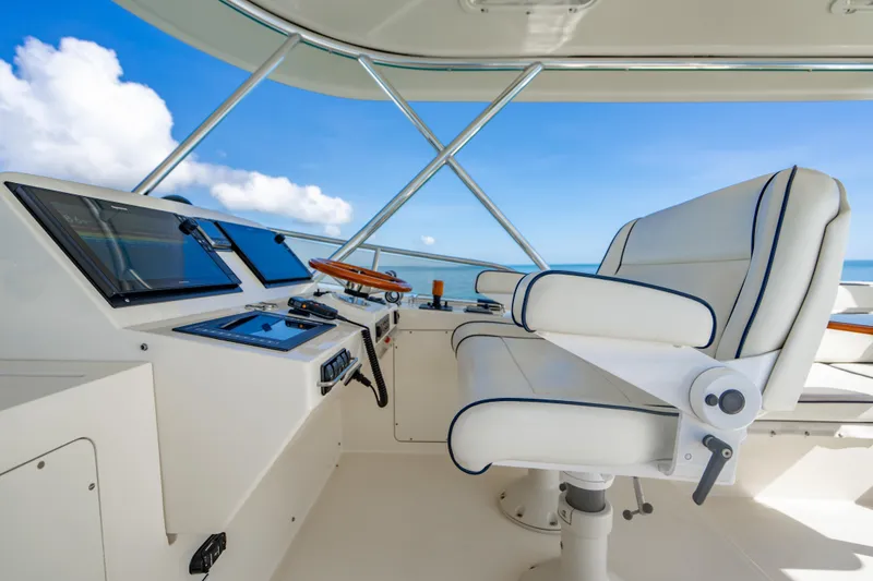 Slide: The Image of Helm of 2007 Hinckley Talaria 55 FB yacht with white captain's chair and navigation controls. - 35