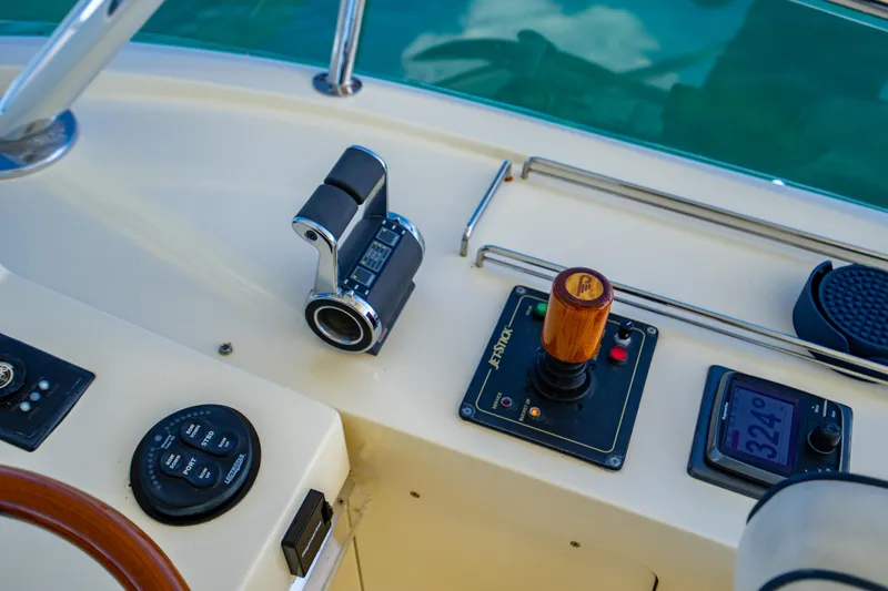 Slide: The Image of Control panel of a 2007 Hinckley Talaria 55 FB yacht with throttle and navigation instruments. - 38