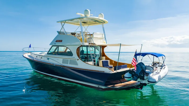 Slide: The Image of 2007 Hinckley Talaria 55 FB yacht on calm blue water, rear view. - 4