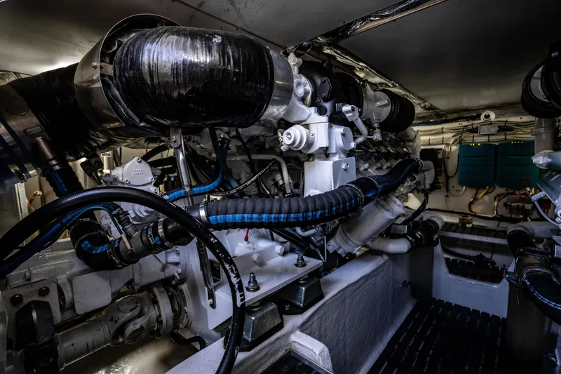 Slide: The Image of Engine room of a 2007 Hinckley Talaria 55 FB yacht, showcasing complex machinery and piping. - 44