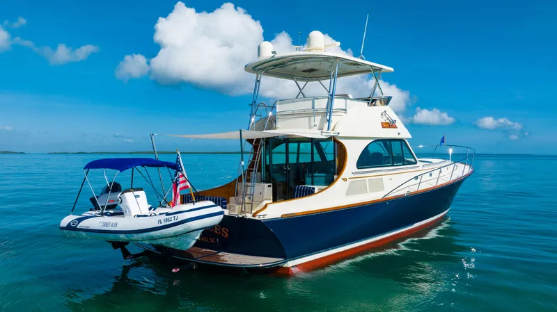 Slide: The Image of 2007 Hinckley Talaria 55 FB yacht on calm blue waters. - 6