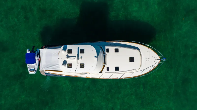 Slide: The Image of Aerial view of 2007 Hinckley Talaria 55 FB yacht on clear green water. - 7