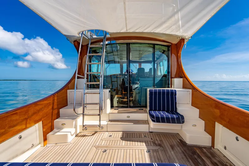 Slide: The Image of 2007 Hinckley Talaria 55 FB yacht deck with seating, ladder, and ocean view. - 9