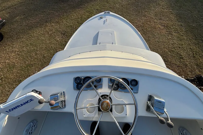 Slide: The Image of 1966 Bertram 25 boat dashboard with steering wheel and controls. - 12