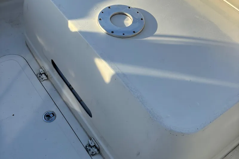 Slide: The Image of 1966 Bertram 25 boat deck with metal fixture, showing clean white surface. - 16