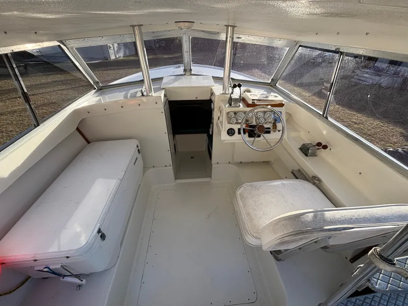 Slide: The Image of Interior of a 1966 Bertram 25 boat, featuring helm and seating area. - 3