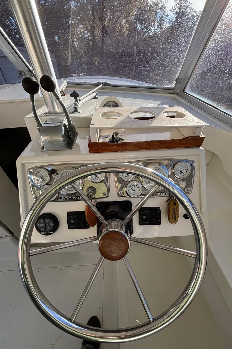 Slide: The Image of 1966 Bertram 25 boat helm with steering wheel and instrument panel. - 8