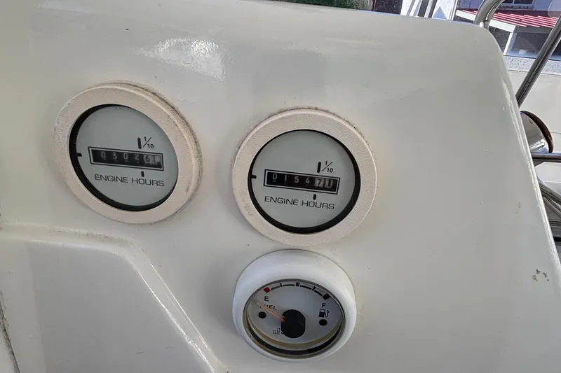 Slide: The Image of 1966 Bertram 25 engine hour meters and gauge on dashboard. - 9