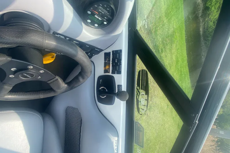 Slide: The Image of 2005 Calabria Cal-Air boat dashboard with steering wheel and control panel. - 12