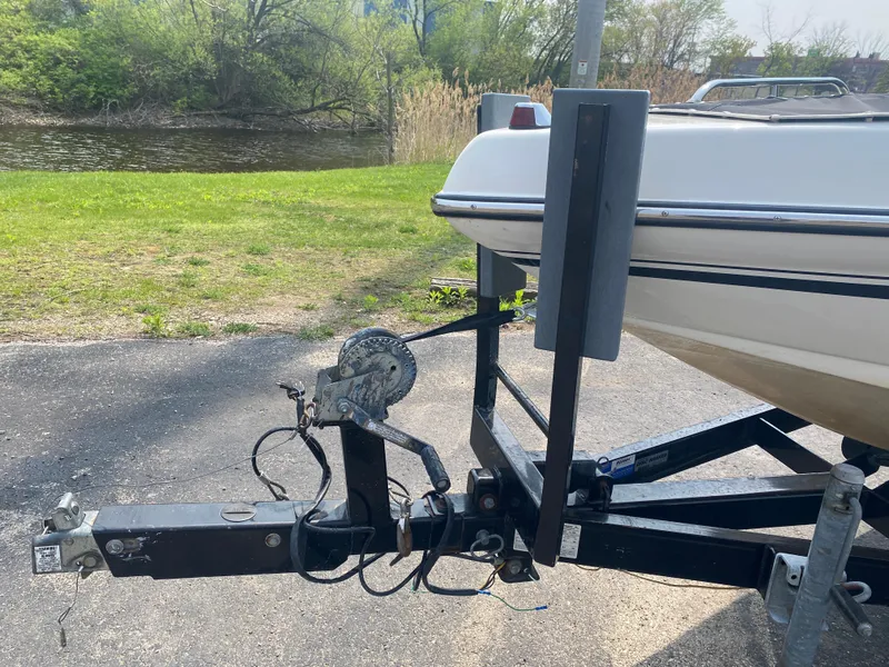 Slide: The Image of 2005 Calabria Cal-Air boat on trailer near a riverbank. - 6
