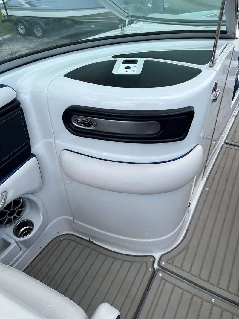 Slide: The Image of 2023 Crownline 270 SS SURF boat interior, featuring sleek dashboard and seating area. - 10