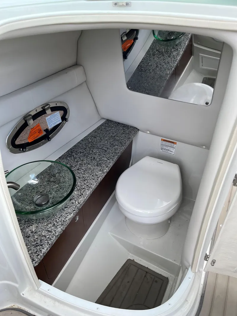 Slide: The Image of 2023 Crownline 270 SS SURF boat bathroom with granite countertop and modern fixtures. - 11