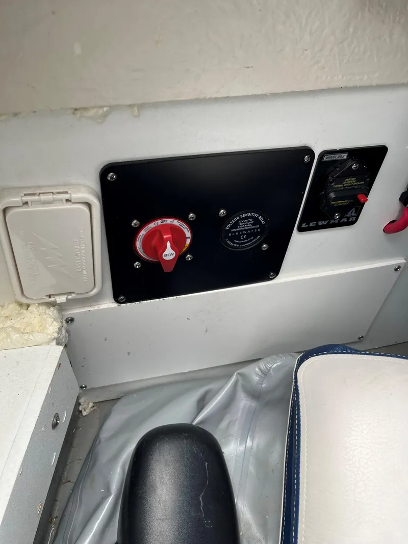Slide: The Image of Control panel of 2023 Crownline 270 SS SURF boat with red switch and black knob. - 13