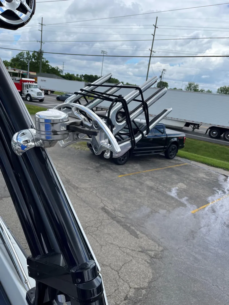 Slide: The Image of Close-up of 2023 Crownline 270 SS SURF boat rack in a parking lot. - 16