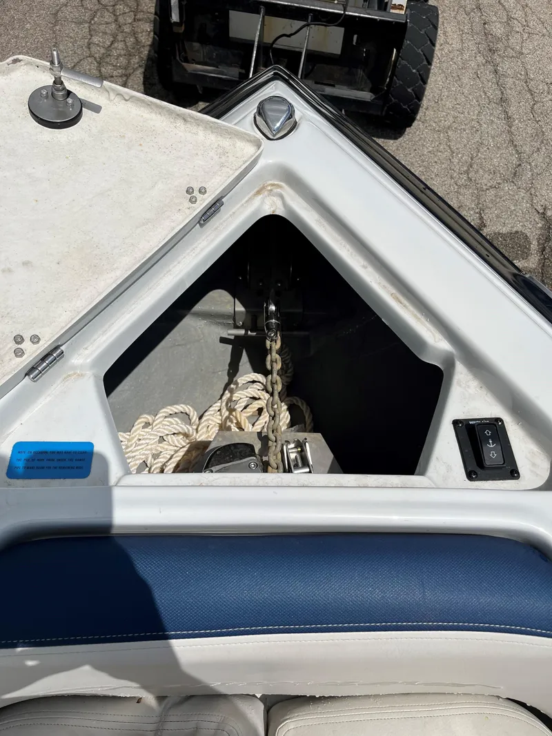 Slide: The Image of 2023 Crownline 270 SS SURF boat anchor storage compartment with ropes and anchor chain. - 4