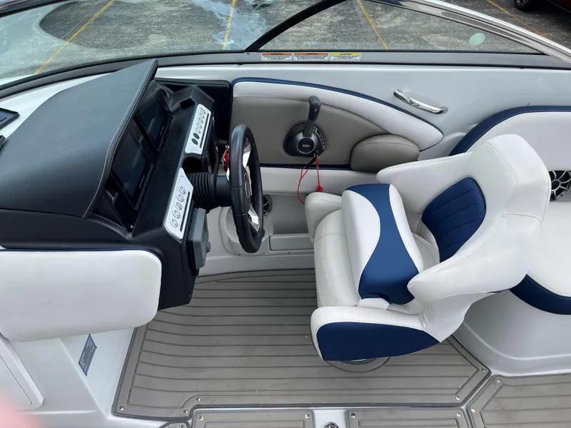 Slide: The Image of 2023 Crownline 270 SS SURF boat interior with captain's chair and dashboard. - 7