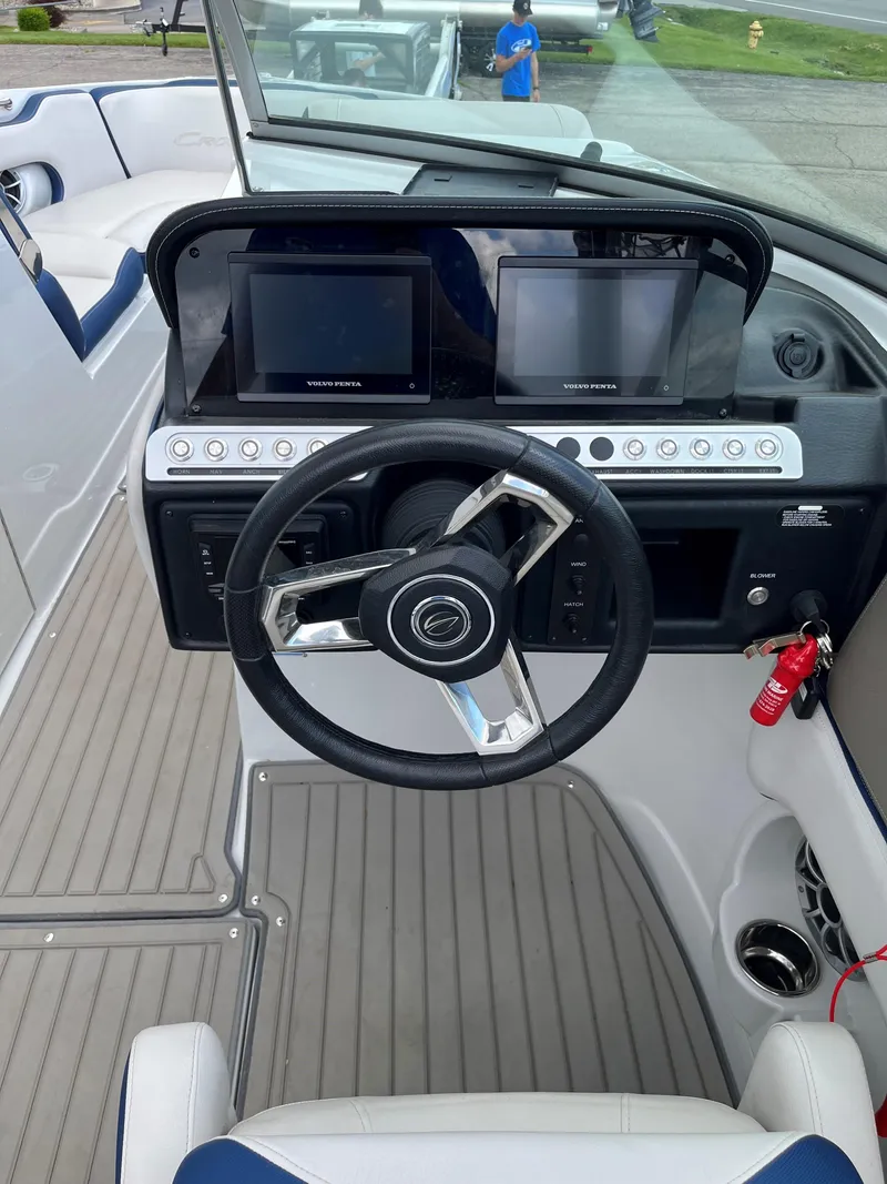 Slide: The Image of 2023 Crownline 270 SS SURF boat dashboard with dual touchscreen displays and steering wheel. - 8