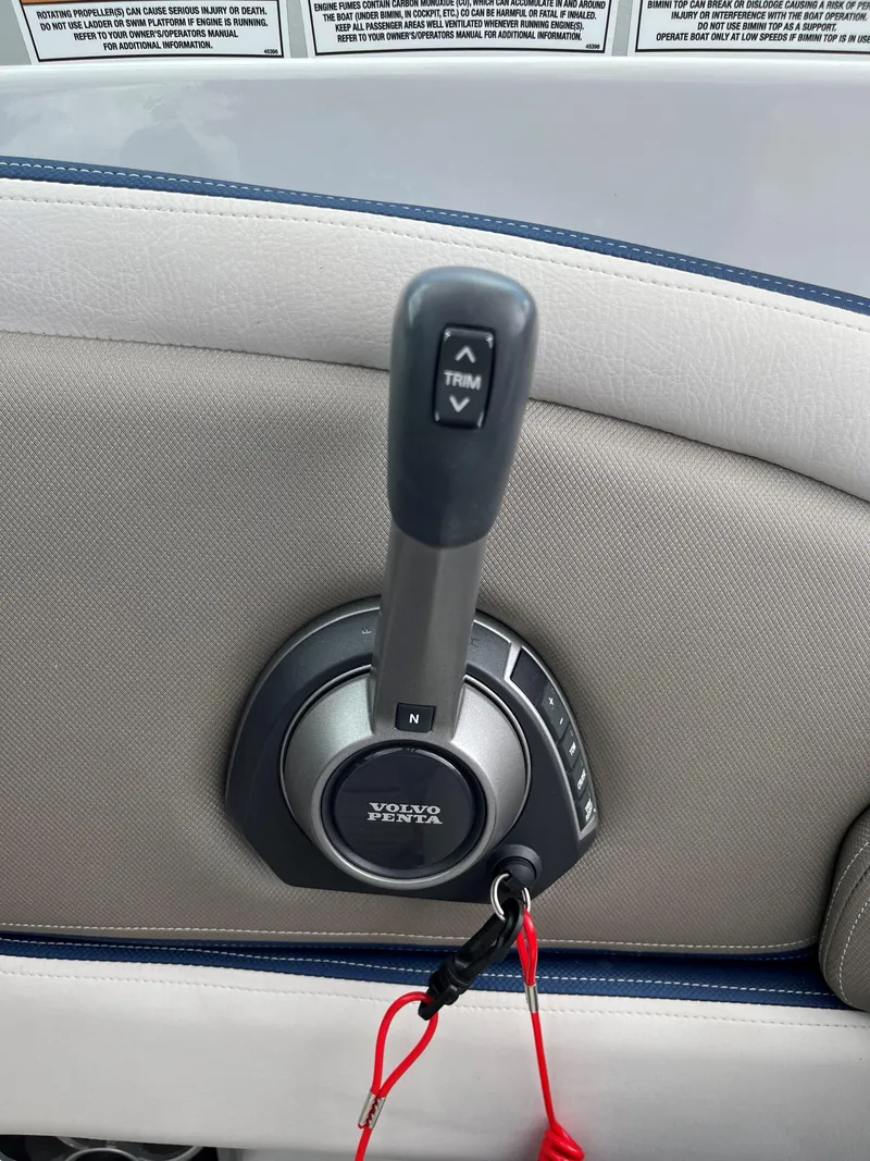 Slide: The Image of Throttle control of 2023 Crownline 270 SS SURF boat with Volvo Penta trim buttons. - 9