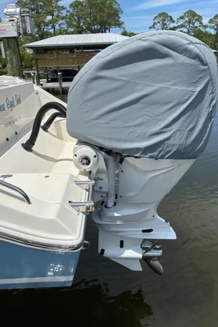 Slide: The Image of 2024 Cobia 301 Center Console boat with covered outboard motor. - 4