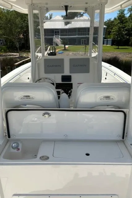 Slide: The Image of 2024 Cobia 301 Center Console boat with dual Garmin displays and spacious deck. - 6