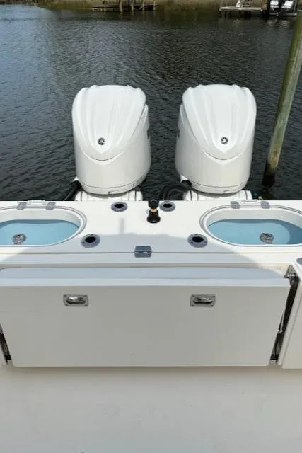 Slide: The Image of 2024 Cobia 301 Center Console with dual outboard engines. - 8