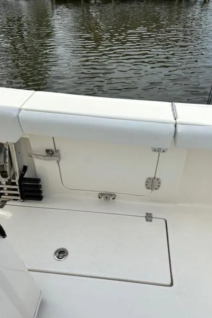 Slide: The Image of 2024 Cobia 301 Center Console boat interior detail by the water. - 9