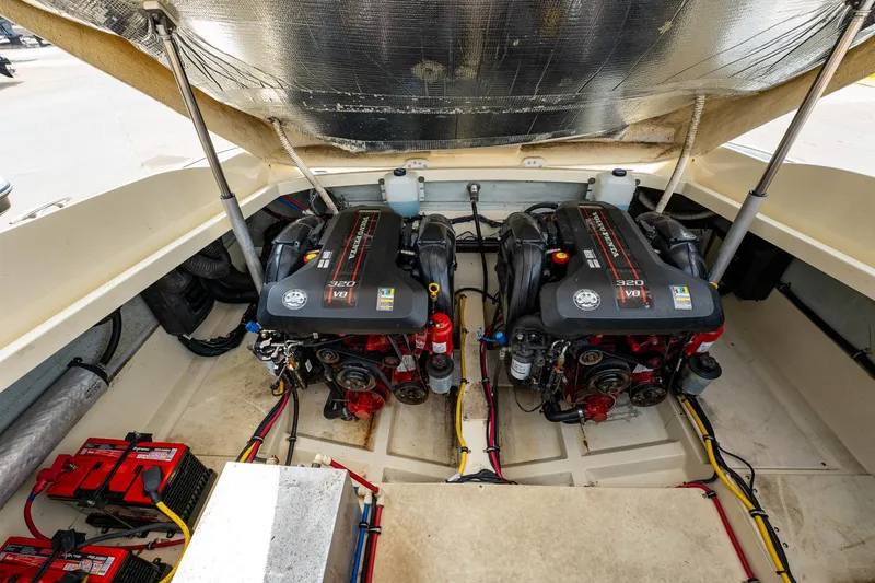 Slide: The Image of 2013 Chris-Craft Launch 32 engine compartment with dual engines and battery setup. - 19