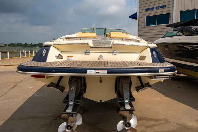 Slide: The Image of 2013 Chris-Craft Launch 32 boat docked, rear view showing dual propellers. - 2