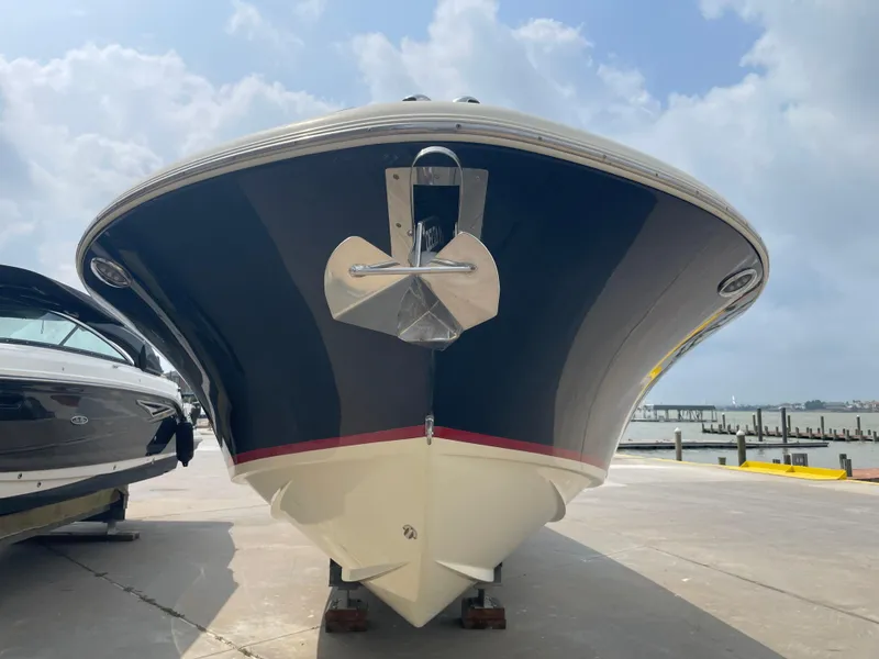 Slide: The Image of 2013 Chris-Craft Launch 32 boat on a dock, front view. - 27