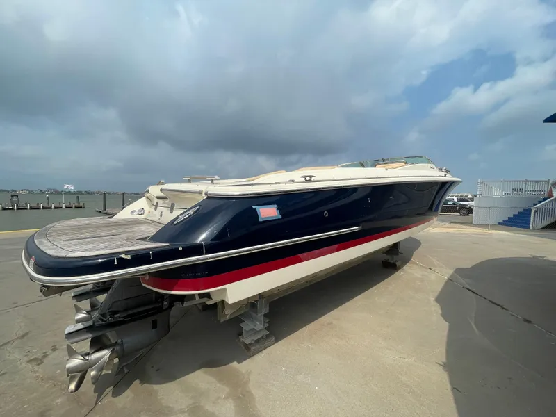 Slide: The Image of 2013 Chris-Craft Launch 32 boat on a dock under a cloudy sky. - 29