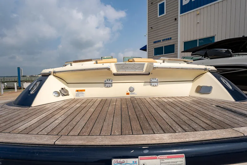 Slide: The Image of 2013 Chris-Craft Launch 32 boat with wooden deck at a marina. - 7