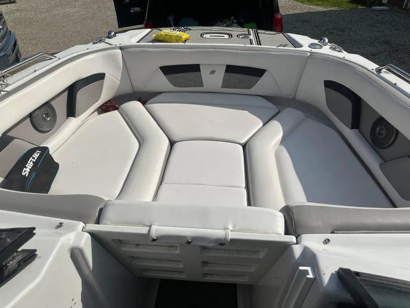 Slide: The Image of 2019 Four Winns HD220 boat interior with white cushioned seating. - 14