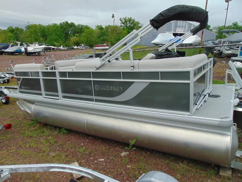 Slide: The Image of 2024 Godfrey Xperience 1880 CX pontoon boat in a boatyard. - 3