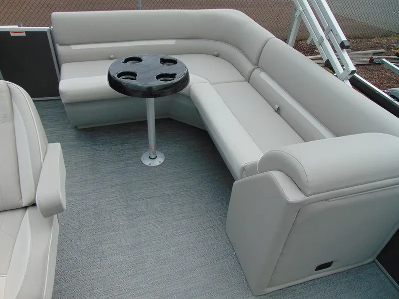 Slide: The Image of 2024 Godfrey Xperience 1880 CX boat interior with plush seating and a round table. - 6