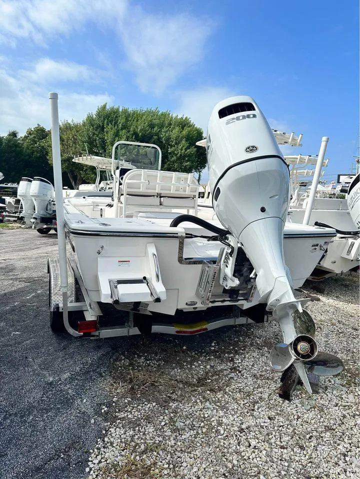 The Image of 2022 Sea Born FX24 boat with outboard motor on a trailer. - 0