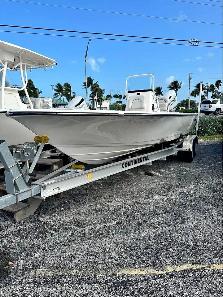 Slide: The Image of 2022 Sea Born FX24 boat on a Continental trailer, parked outdoors. - 5