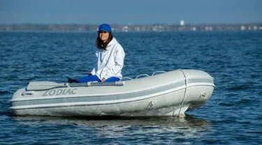 The Image of 2024 Zodiac Nomad RIB ALU 3.1 NEO inflatable boat on water with person onboard. - 1