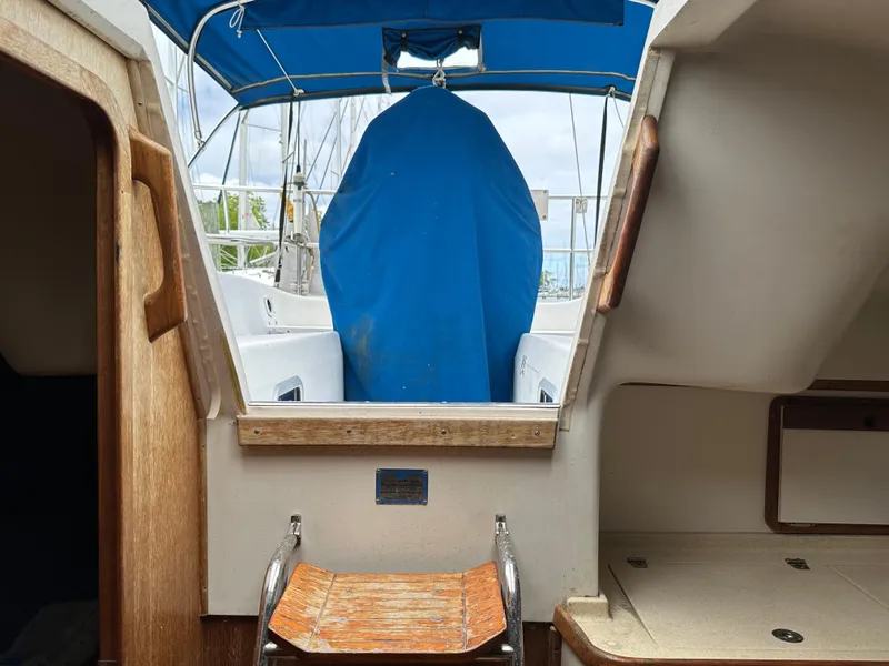 Slide: The Image of 1994 Catalina 320 sailboat interior with blue canopy and wooden steps. - 12