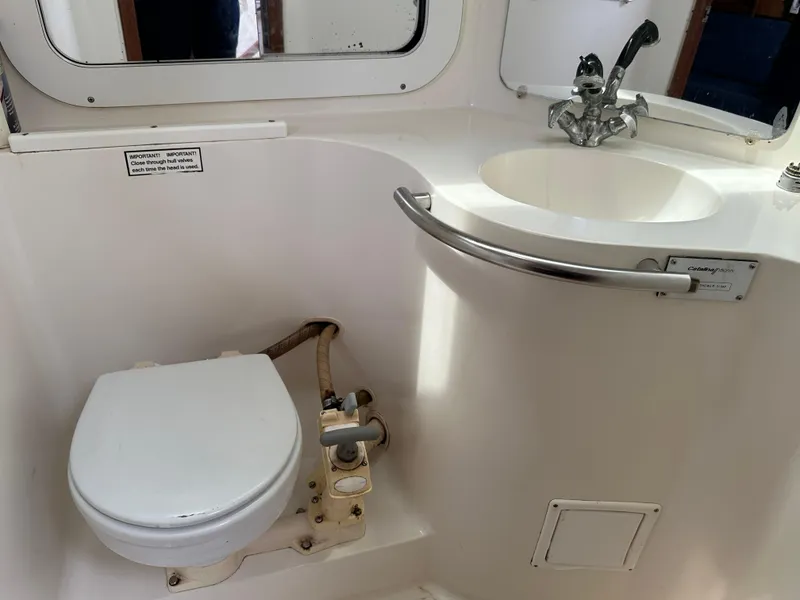 Slide: The Image of 1994 Catalina 320 yacht bathroom with toilet and sink. - 14