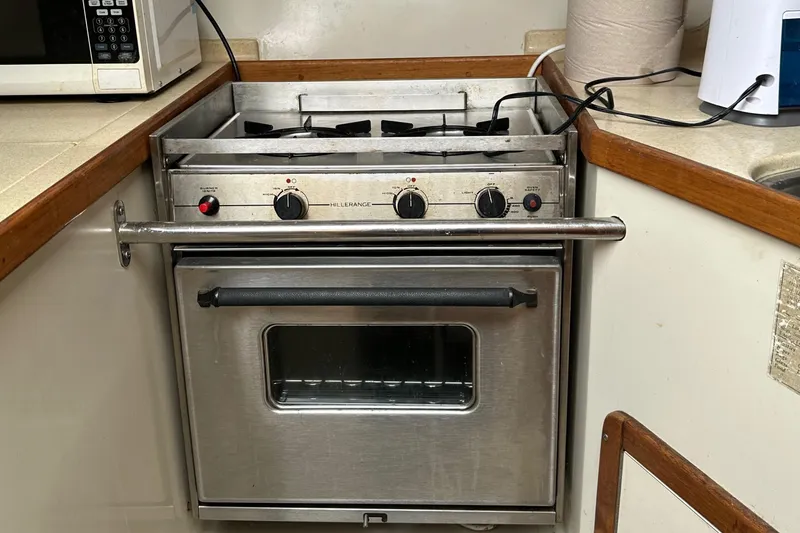 Slide: The Image of 1994 Catalina 320 boat kitchen with stainless steel stove and oven. - 20