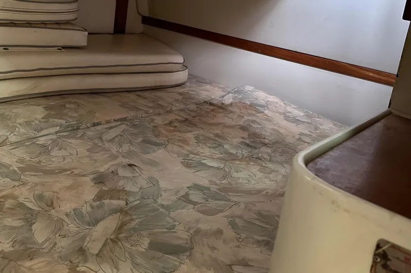 Slide: The Image of Interior cabin of a 1994 Catalina 320 sailboat with floral-patterned upholstery. - 21
