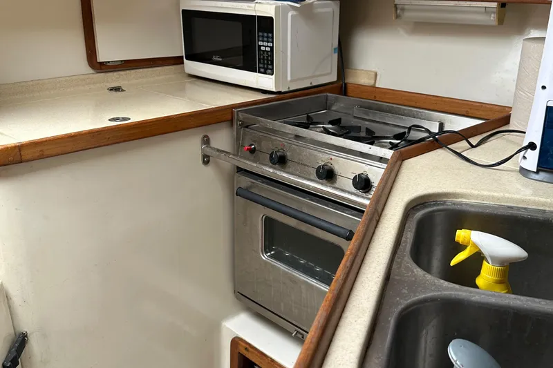 Slide: The Image of Galley kitchen in 1994 Catalina 320 sailboat with stove, microwave, and sink. - 22