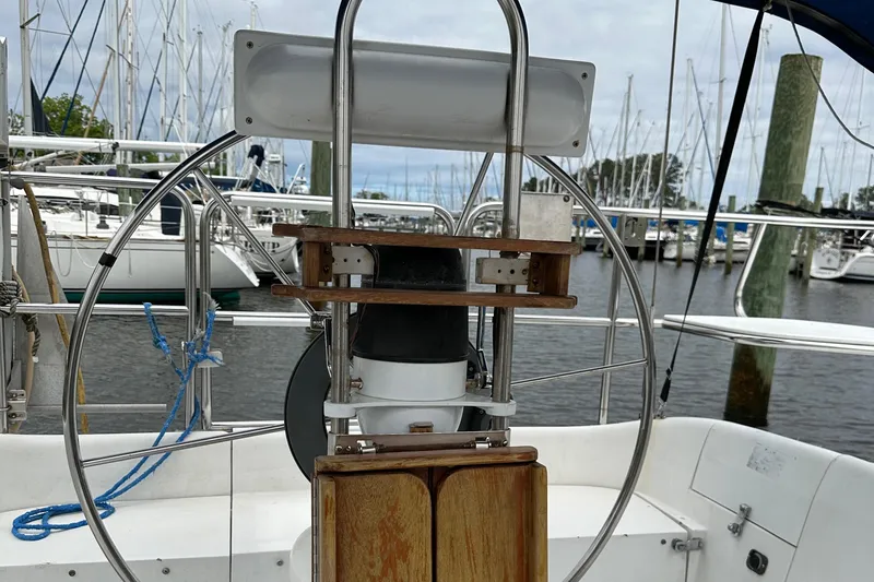 Slide: The Image of Steering wheel of a 1994 Catalina 320 sailboat docked at a marina. - 9